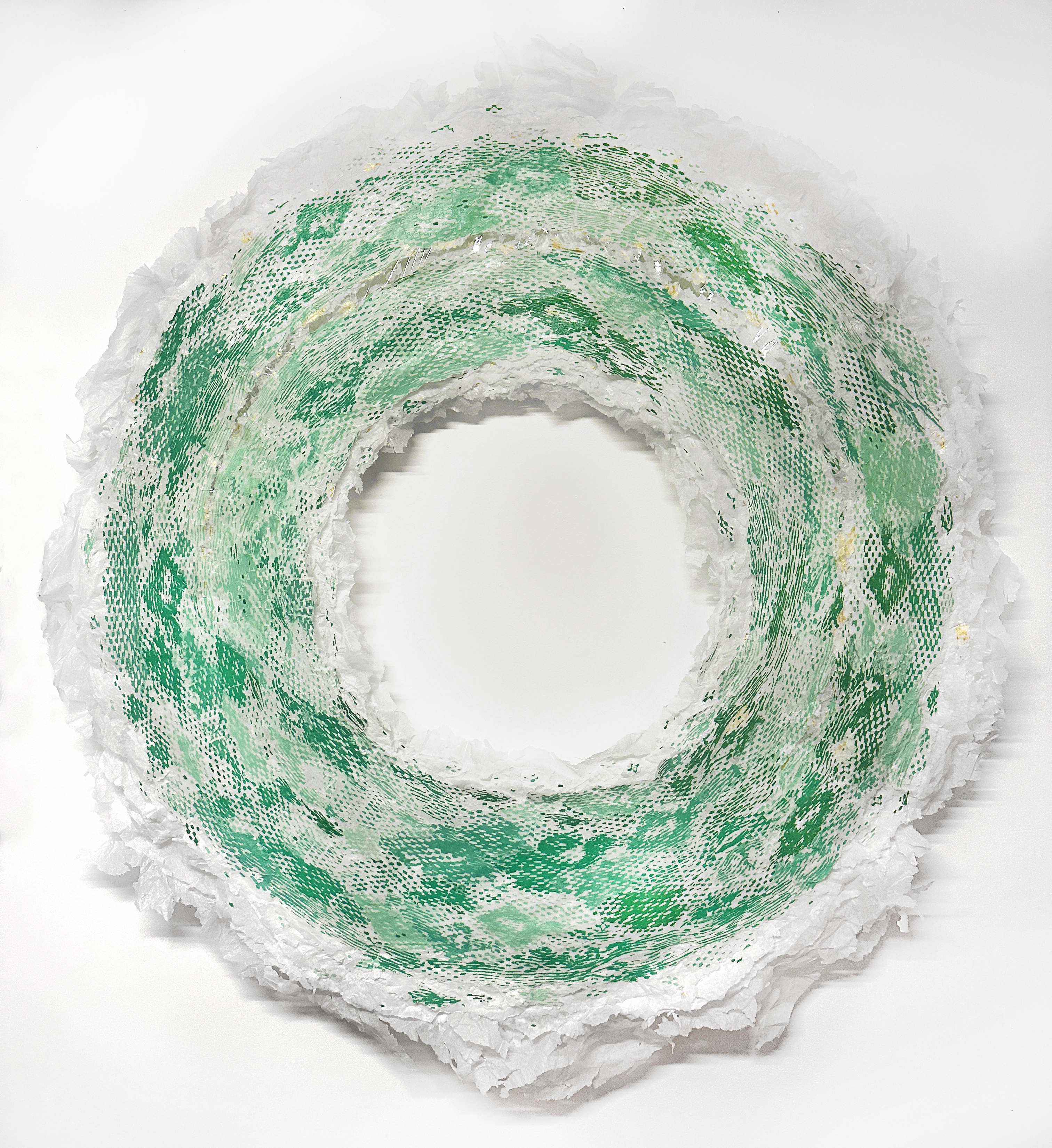 Uncoiling Adult Universe 07.15.25 — a green screen-print collage ring with torn paper edges.